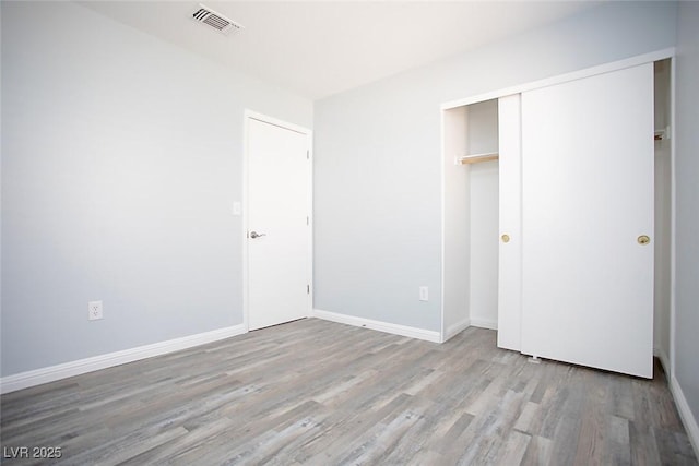 5233 Camino Del Rancho, Las Vegas, NV 89130 - unfurnished bedroom featuring wood finished floors and a closet