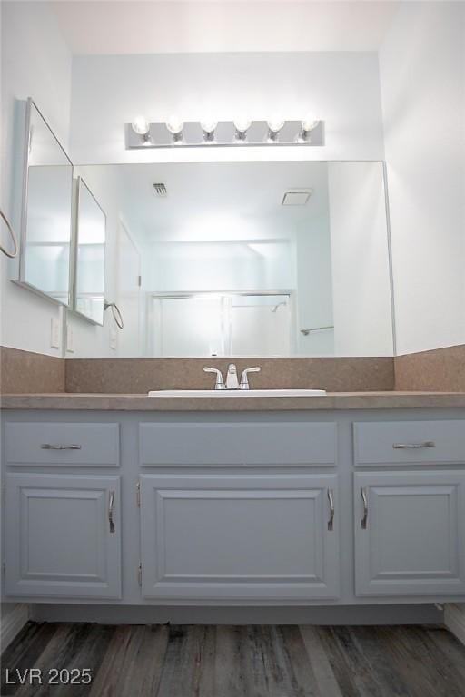 5233 Camino Del Rancho, Las Vegas, NV 89130 - full bath featuring vanity, a shower, and wood finished floors