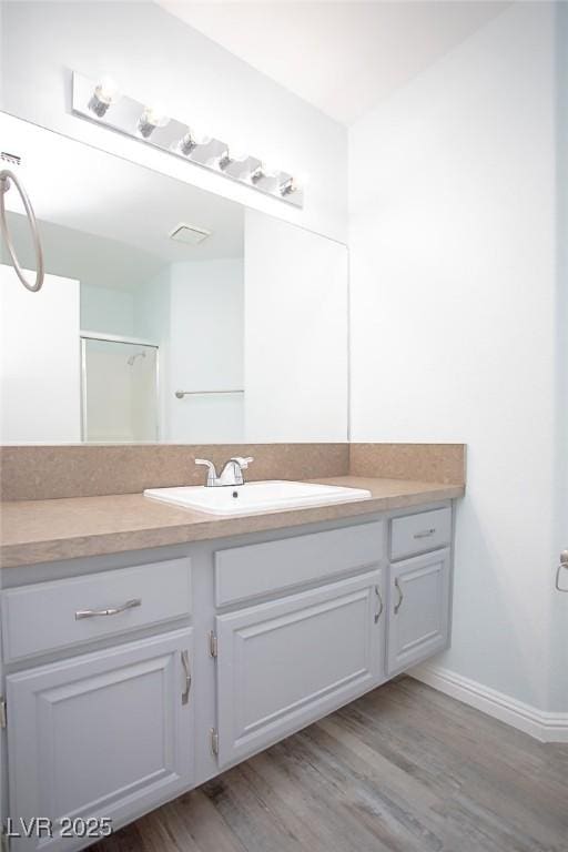 5233 Camino Del Rancho, Las Vegas, NV 89130 - bathroom with vanity, wood finished floors, and an enclosed shower