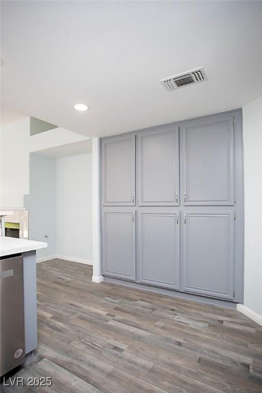 5233 Camino Del Rancho, Las Vegas, NV 89130 - kitchen with gray cabinetry, stainless steel dishwasher, wood finished floors, recessed lighting, and light countertops