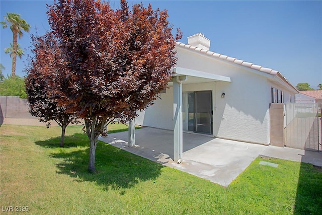 5233 Camino Del Rancho, Las Vegas, NV 89130 - rear view of property featuring a patio, a chimney, stucco siding, and a tiled roof