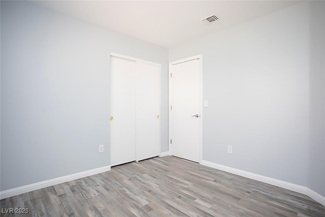 5233 Camino Del Rancho, Las Vegas, NV 89130 - unfurnished bedroom featuring wood finished floors and a closet