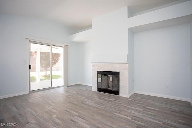5233 Camino Del Rancho, Las Vegas, NV 89130 - unfurnished living room featuring wood finished floors and a tiled fireplace