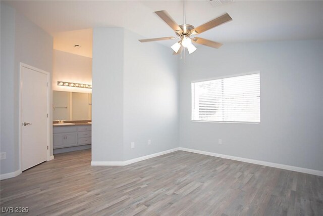 5233 Camino Del Rancho, Las Vegas, NV 89130 - empty room with wood finished floors, a ceiling fan, and vaulted ceiling