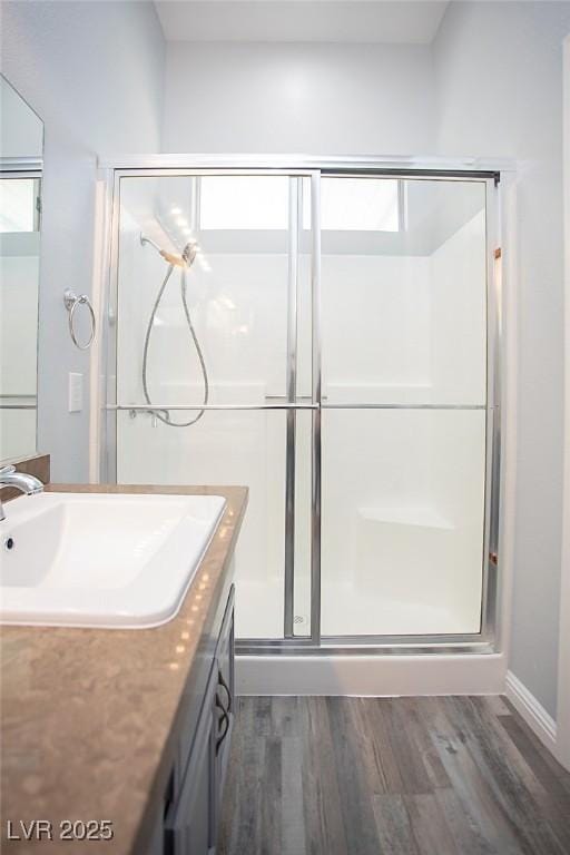 5233 Camino Del Rancho, Las Vegas, NV 89130 - full bathroom with vanity, wood finished floors, and a stall shower
