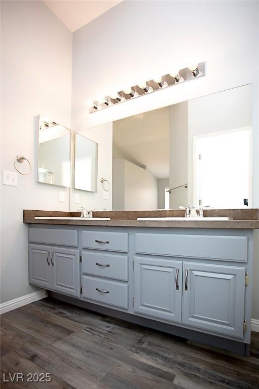 5233 Camino Del Rancho, Las Vegas, NV 89130 - full bathroom featuring double vanity and wood finished floors