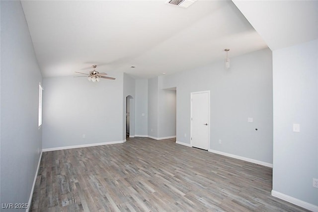 5233 Camino Del Rancho, Las Vegas, NV 89130 - empty room with arched walkways, a ceiling fan, wood finished floors, and lofted ceiling