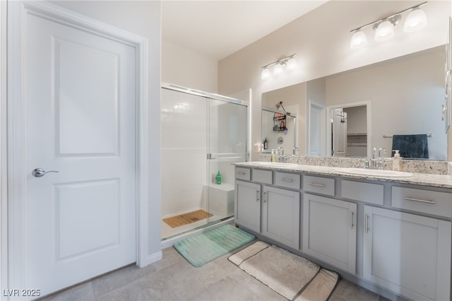 7910 Shimmery St, North Las Vegas, NV 89084 - full bathroom with a shower stall, double vanity, tile patterned flooring, and a walk in closet