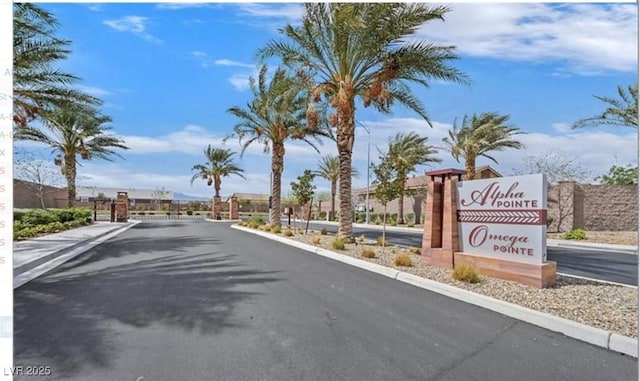 7910 Shimmery St, North Las Vegas, NV 89084 - view of asphalt street featuring a gated entry and curbs
