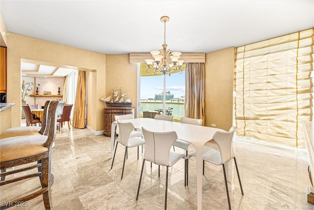 2877 Paradise Rd Unit 702, Las Vegas, NV 89109 - dining room with a chandelier and baseboards