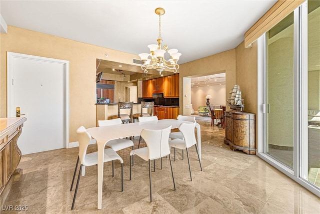2877 Paradise Rd Unit 702, Las Vegas, NV 89109 - dining area featuring a chandelier