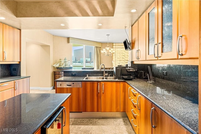 2877 Paradise Rd Unit 702, Las Vegas, NV 89109 - kitchen featuring dishwashing machine, a peninsula, tasteful backsplash, beverage cooler, and dark stone counters