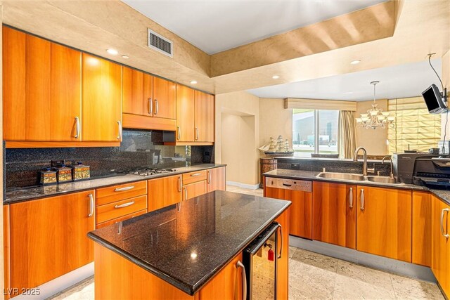 2877 Paradise Rd Unit 702, Las Vegas, NV 89109 - kitchen featuring brown cabinets, beverage cooler, decorative backsplash, dark stone countertops, and recessed lighting