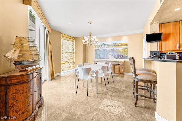 2877 Paradise Rd Unit 702, Las Vegas, NV 89109 - dining room featuring a chandelier and baseboards