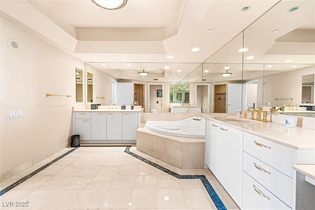2877 Paradise Rd Unit 702, Las Vegas, NV 89109 - bathroom with a jetted tub, inlaid floor details, two vanities, and recessed lighting