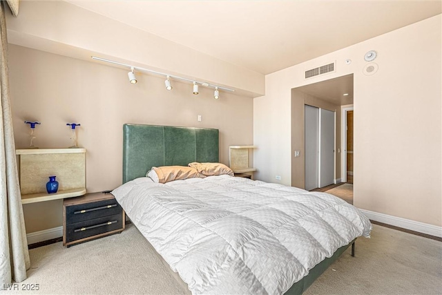 2877 Paradise Rd Unit 702, Las Vegas, NV 89109 - carpeted bedroom with rail lighting and baseboards