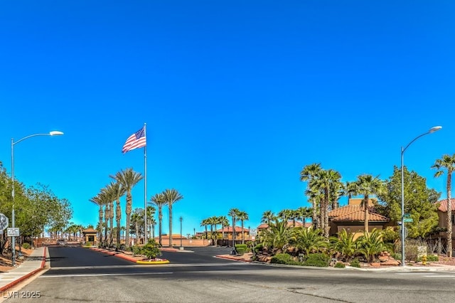 1097 Paradise Resort Dr, Henderson, NV 89002 - view of asphalt road featuring curbs, street lights, sidewalks, and traffic signs