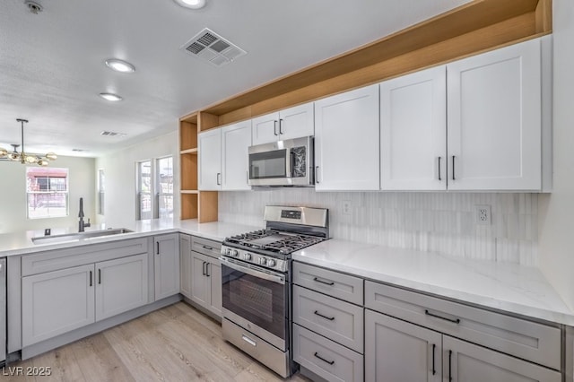 1097 Paradise Resort Dr, Henderson, NV 89002 - kitchen with stainless steel appliances, open shelves, decorative backsplash, light wood-type flooring, and recessed lighting
