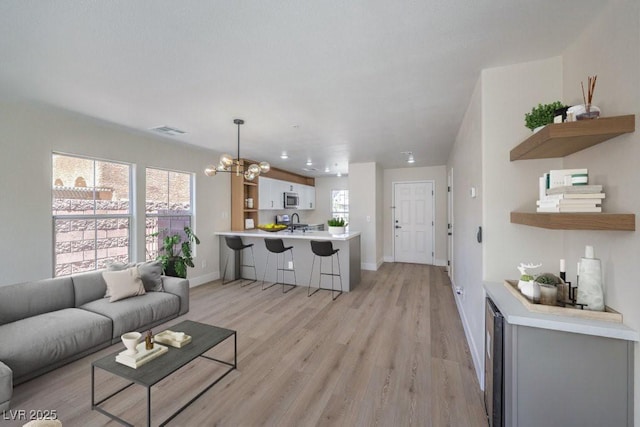 1097 Paradise Resort Dr, Henderson, NV 89002 - living area featuring a chandelier and light wood-style floors