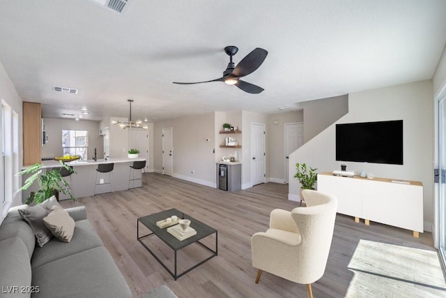 1097 Paradise Resort Dr, Henderson, NV 89002 - living area with a chandelier, light wood-style floors, and ceiling fan