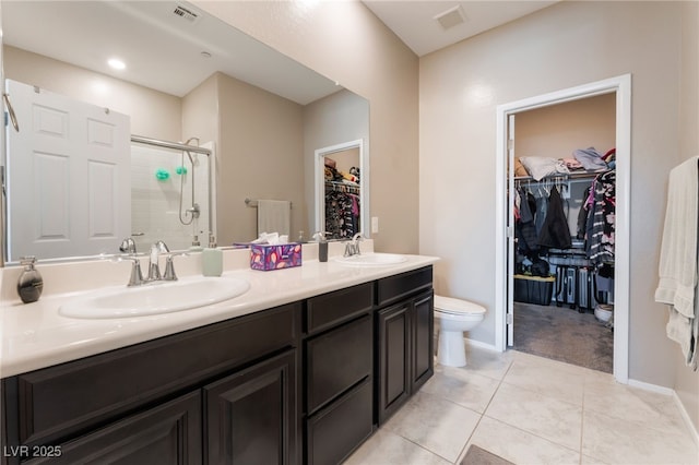 2861 Sunflower Days Ave Unit 1144, North Las Vegas, NV 89031 - bathroom with a stall shower, a walk in closet, double vanity, and tile patterned flooring