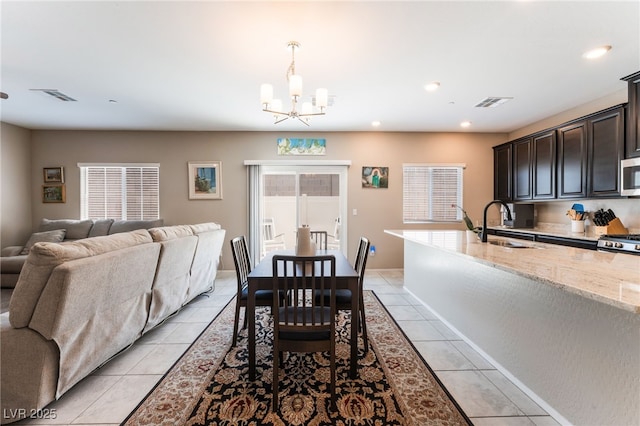 2861 Sunflower Days Ave Unit 1144, North Las Vegas, NV 89031 - dining area with light tile patterned flooring, a chandelier, and recessed lighting