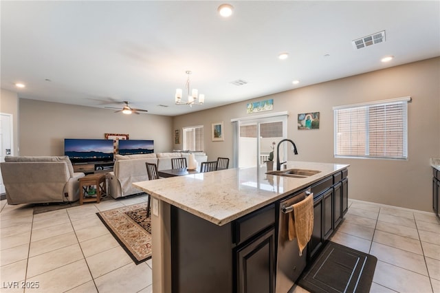 2861 Sunflower Days Ave Unit 1144, North Las Vegas, NV 89031 - kitchen with dishwasher, light tile patterned floors, a chandelier, a ceiling fan, and a kitchen island with sink