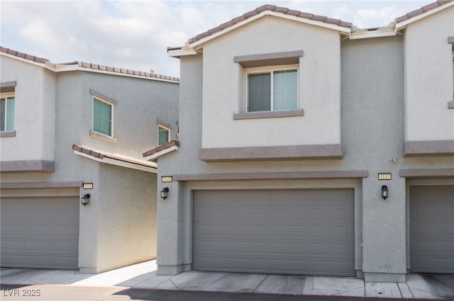 2861 Sunflower Days Ave Unit 1144, North Las Vegas, NV 89031 - view of property with a garage, stucco siding, and a tiled roof