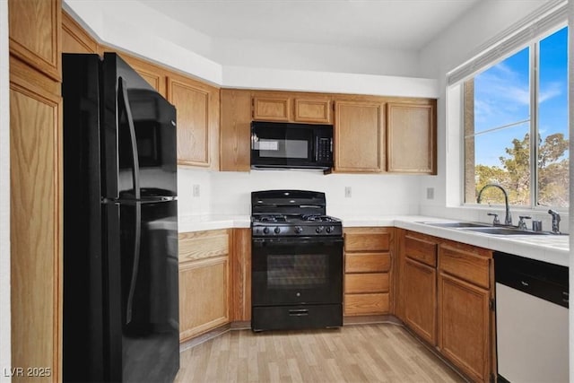 5155 W Tropicana Ave Unit 2017, Las Vegas, NV 89103 - kitchen featuring black appliances, light wood-type flooring, and tile countertops