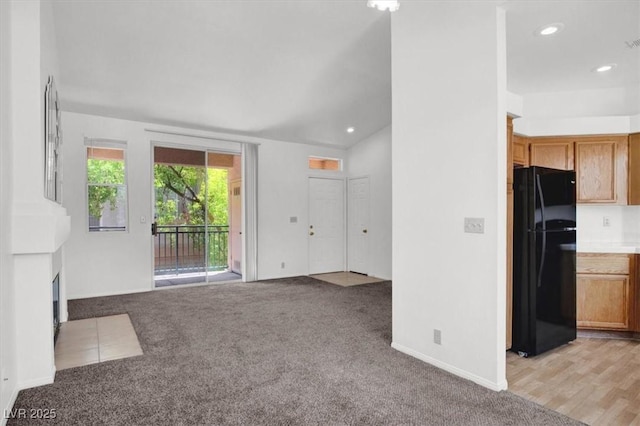 5155 W Tropicana Ave Unit 2017, Las Vegas, NV 89103 - unfurnished living room with light colored carpet, a fireplace with flush hearth, and recessed lighting