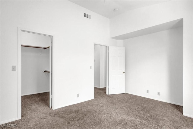 5155 W Tropicana Ave Unit 2017, Las Vegas, NV 89103 - unfurnished bedroom with carpet flooring, a spacious closet, a towering ceiling, and a closet