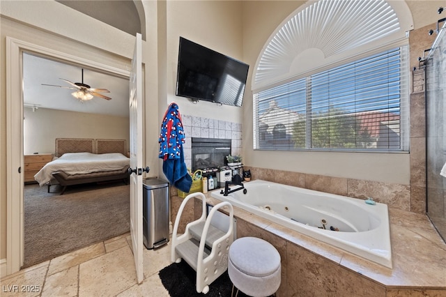2637 Ohio Ct, Las Vegas, NV 89128 - full bath with ensuite bath, a jetted tub, a tiled fireplace, a ceiling fan, and stone finish flooring
