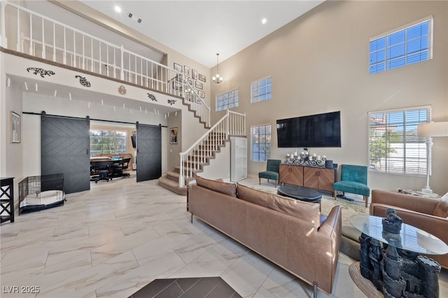 2637 Ohio Ct, Las Vegas, NV 89128 - living room with a barn door, stairway, a towering ceiling, and marble finish floors