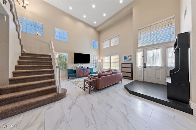 2637 Ohio Ct, Las Vegas, NV 89128 - living area with a towering ceiling, light marble finish flooring, stairs, and recessed lighting