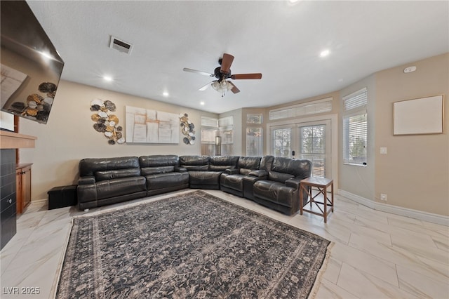 2637 Ohio Ct, Las Vegas, NV 89128 - living area with light marble finish flooring, ceiling fan, a tiled fireplace, and recessed lighting