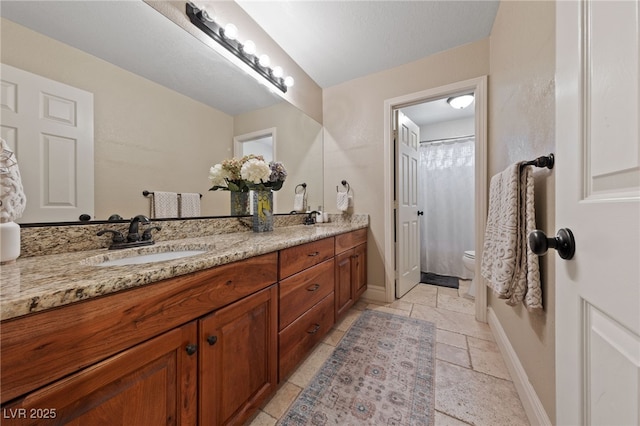 2637 Ohio Ct, Las Vegas, NV 89128 - full bathroom featuring double vanity and stone tile floors