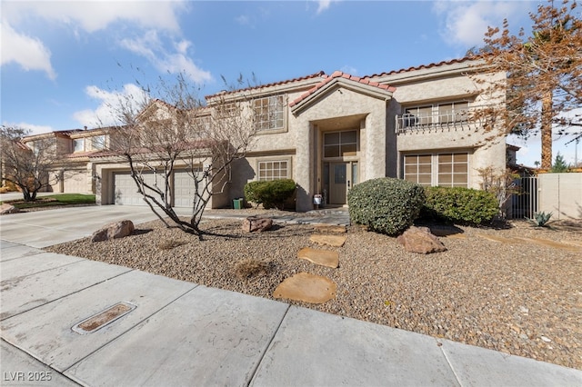 2637 Ohio Ct, Las Vegas, NV 89128 - view of front of home featuring driveway, stucco siding, a tile roof, a balcony, and an attached garage