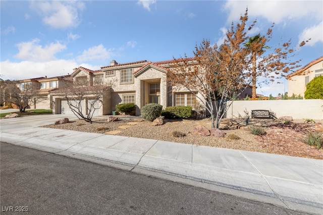 2637 Ohio Ct, Las Vegas, NV 89128 - view of front of house featuring stone siding, driveway, stucco siding, a chimney, and a tiled roof