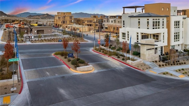 650 Agate Bridge St, Las Vegas, NV 89138 - view of asphalt street featuring traffic signs, curbs, a mountain view, and sidewalks