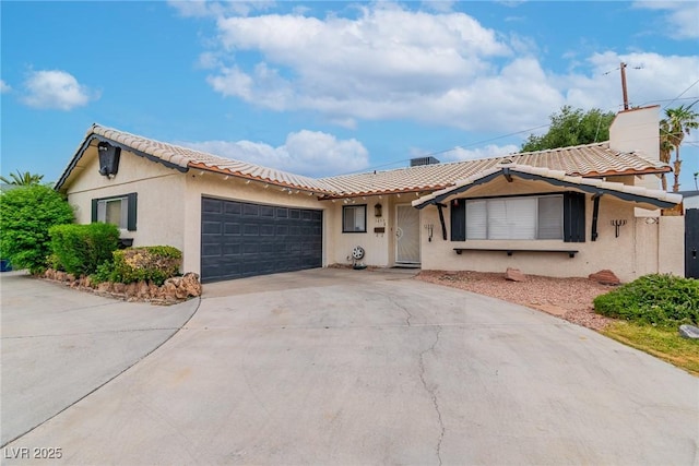3499 Middlebury Ave, Las Vegas, NV 89121 - view of front of home with driveway, an attached garage, a tile roof, and stucco siding