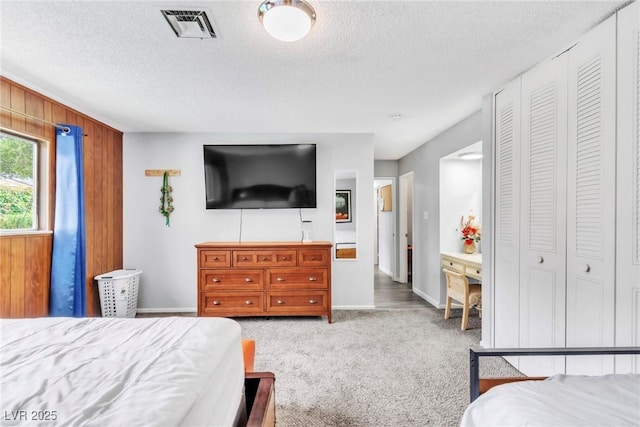 3499 Middlebury Ave, Las Vegas, NV 89121 - bedroom with carpet flooring, a textured ceiling, and wood walls