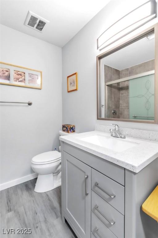 3499 Middlebury Ave, Las Vegas, NV 89121 - full bathroom with vanity, wood finished floors, and a tile shower