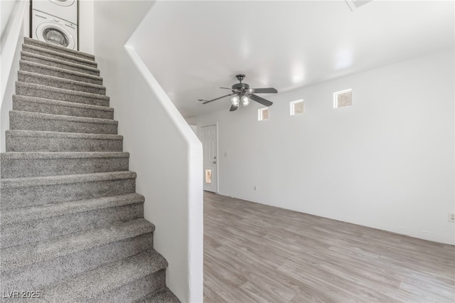 2149 Clancy St, Las Vegas, NV 89156 - stairs featuring estacked washer and dryer, ceiling fan, and wood finished floors