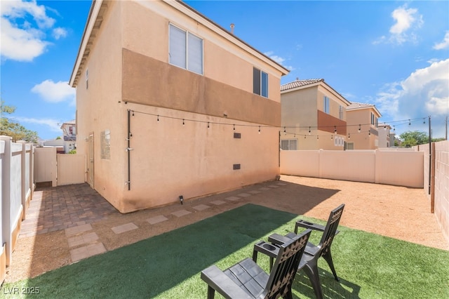 2149 Clancy St, Las Vegas, NV 89156 - rear view of house with a fenced backyard, stucco siding, and a patio area