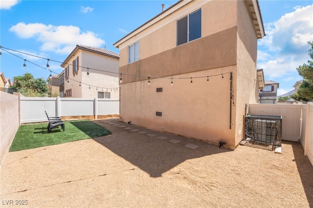 2149 Clancy St, Las Vegas, NV 89156 - back of property featuring stucco siding, a fenced backyard, and a patio area