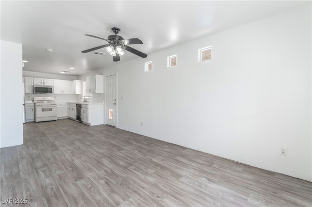 2149 Clancy St, Las Vegas, NV 89156 - unfurnished living room featuring a ceiling fan, light wood-type flooring, and recessed lighting