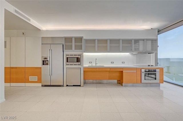 3726 S Las Vegas Blvd Unit 1003, Las Vegas, NV 89158 - kitchen with built in appliances, glass insert cabinets, light countertops, modern cabinets, and extractor fan