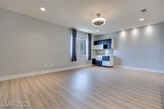 10342 Kesington Dr, Las Vegas, NV 89135 - unfurnished living room featuring light wood finished floors and recessed lighting