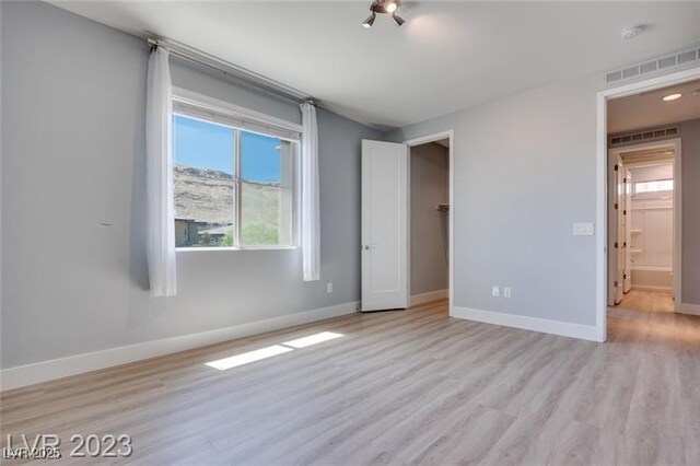 10342 Kesington Dr, Las Vegas, NV 89135 - unfurnished bedroom with light wood-type flooring and baseboards