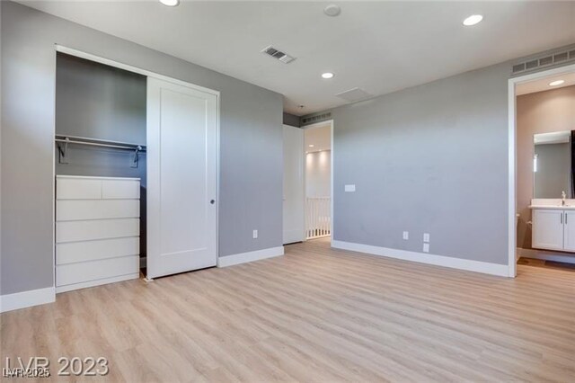 10342 Kesington Dr, Las Vegas, NV 89135 - unfurnished bedroom featuring light wood-style floors, recessed lighting, ensuite bathroom, and a closet